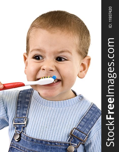 Young boy brushing his teeth with toothbrush, isolated in white