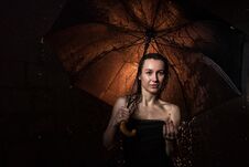 Girl In Black Dress With Umbrella And Drops Of Water Stock Images