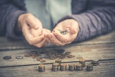 Money, Coins, The Grandmother On Pensions And A Concept Of A Living Minimum - In Hands Of The Old Woman Isn`t Enough Money Stock Photo