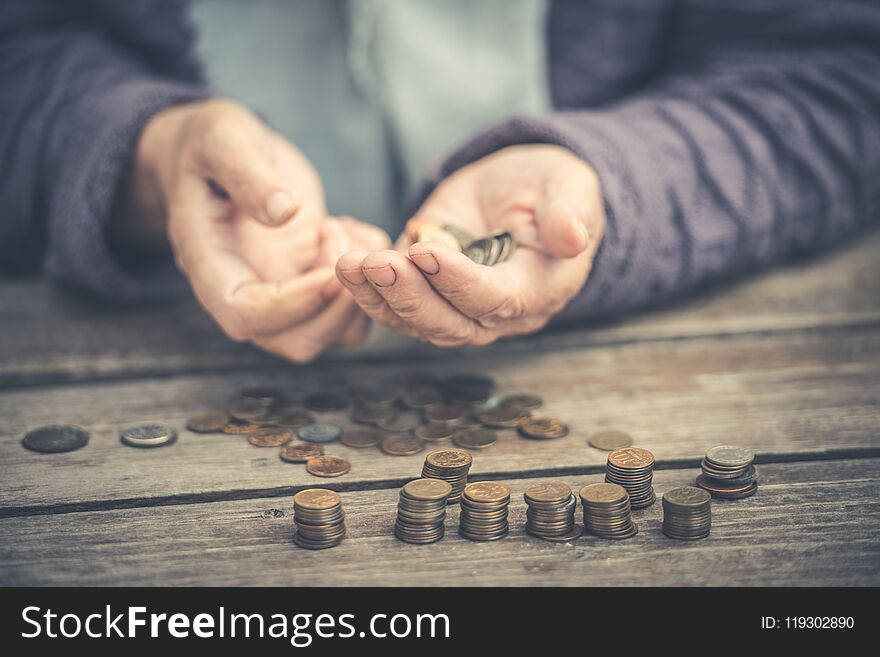 Money, coins, the grandmother on pensions and a concept of a living minimum - in hands of the old woman isn`t enough money