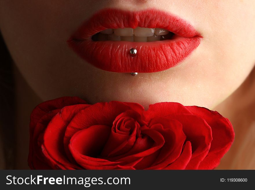 Woman Wearing Red Lipstick Near Red Rose