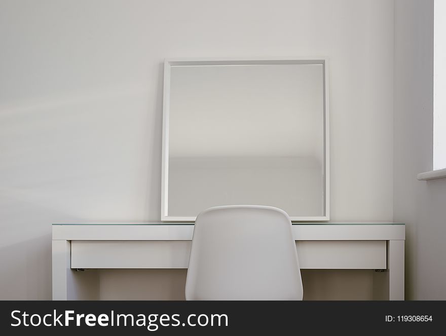 Chair in Front of Desk With Mirror on Top