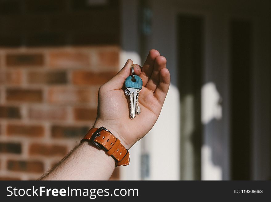 Person Holding Silver Keys