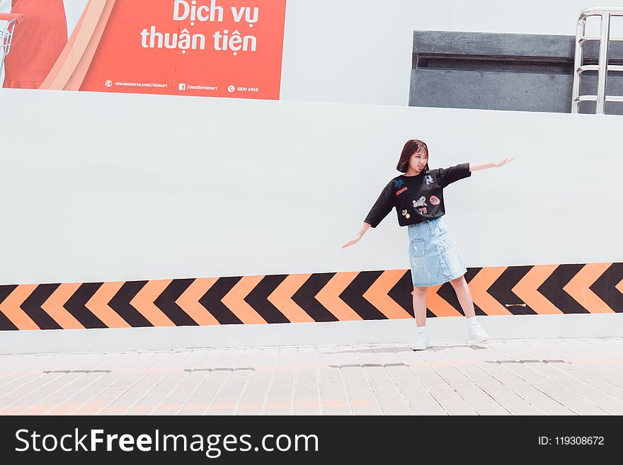 Woman In Black Shirt Standing Near Building