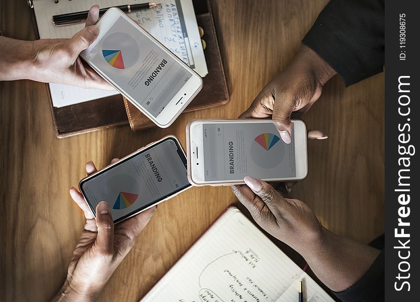 Three People Holding Phone Displaying Branding Pie Chart