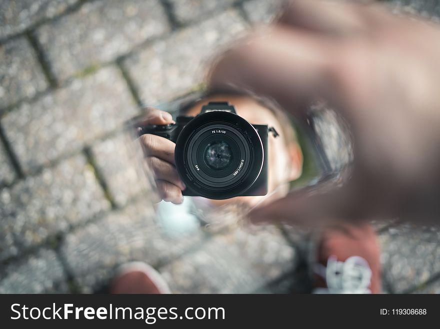 Selective Photo of Person Holds Black Dslr Camera