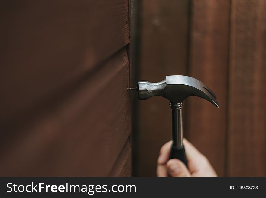 Person Holding Curved Claw Hammer