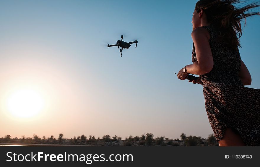 Woman Holding Remote of Drone