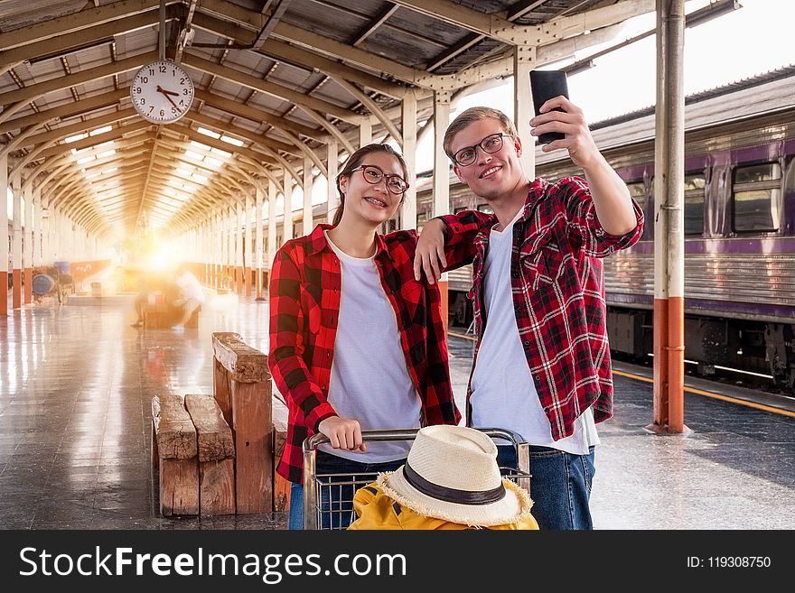 Man and Woman at the Train Station Taking a Selfie