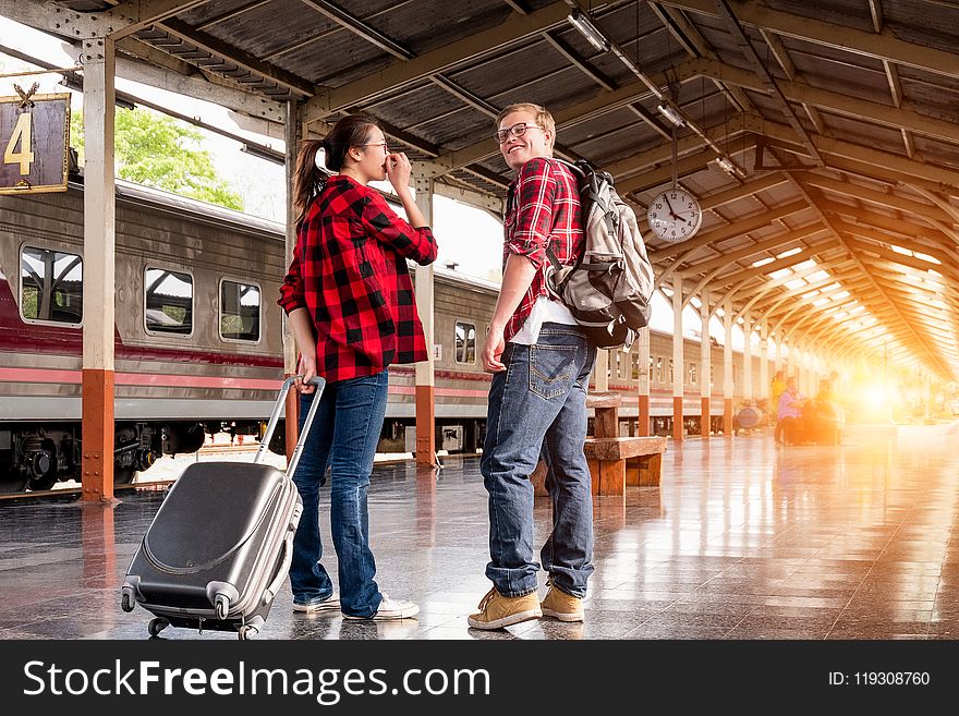 Man and Woman in Red Flannel Shirts at the Subway