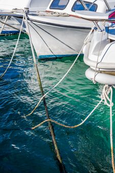 View Of Boats And Ropes Moored In The Marina In A Clear Blue Sea Royalty Free Stock Image