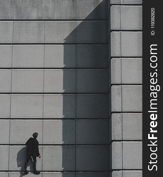 Photo Of Man Standing On Concrete Building