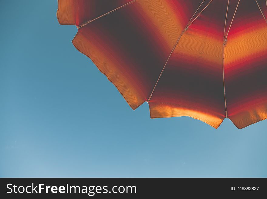 Low Angle Photography of Black and Orange Beach Umbrella