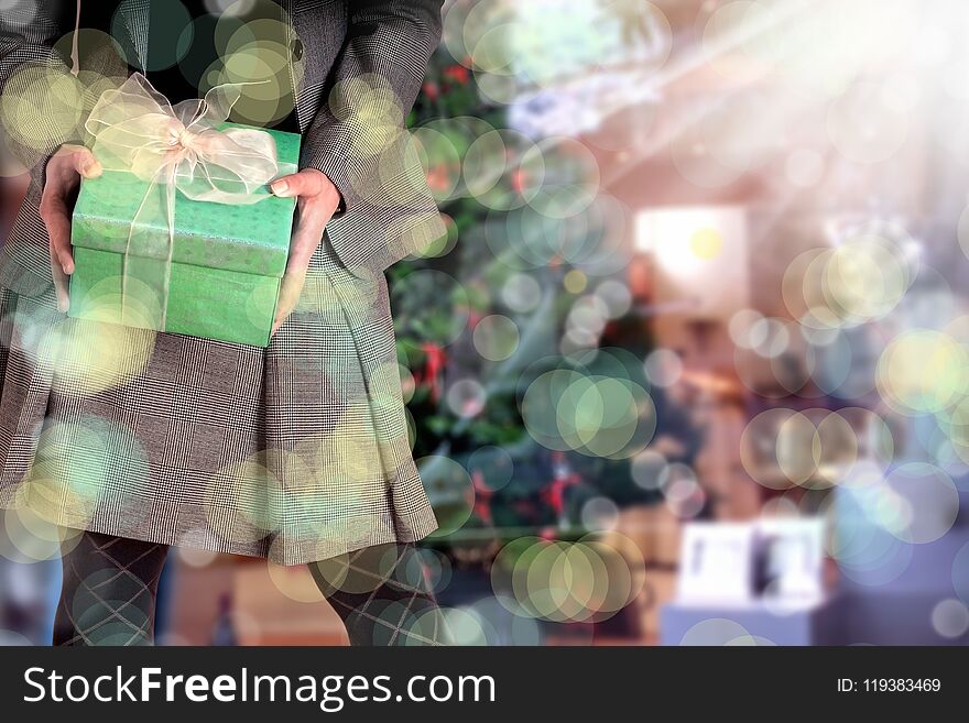 woman holding giftbox and Christmas tree