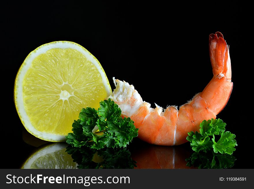 Fresh shrimp with slice of lemon on black background. Fresh shrimp with slice of lemon on black background.