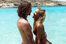 Young Tanned Couple Standing In The Sea In Blue Tropical Lagoon,looking At Each Other With Tenderness,love Concept,traveling Royalty Free Stock Photos Young Tanned Couple Standing In The Sea In Blue Tropical Lagoon,looking At Each Other With Tenderness,love Concept,traveling Royalty Free Stock Photos