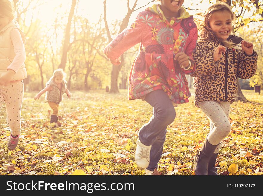 Kids running trough park together. Day for fun at nature. Kids running trough park together. Day for fun at nature.