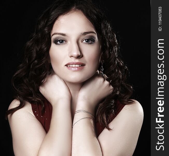 Closeup. portrait of beautiful woman in red dress posing for the camera.isolated on black background