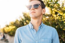 Beautiful Stylish Guy With Glasses, Posing On The Beach, At Sunset, Hipster Posing In Stylish Clothes, For Advertising, Text Inser Stock Image Beautiful Stylish Guy With Glasses, Posing On The Beach, At Sunset, Hipster Posing In Stylish Clothes, For Advertising, Text Inser Stock Image