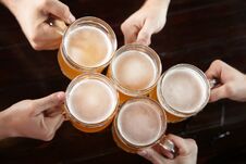 Friends Clinking Glasses With Beer Stock Image