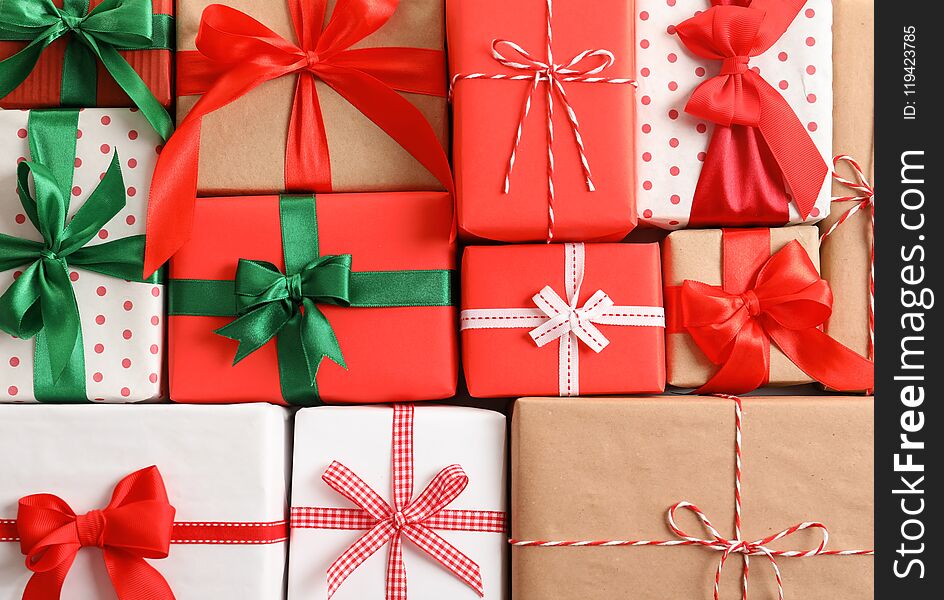 Beautifully wrapped gift boxes as background, closeup