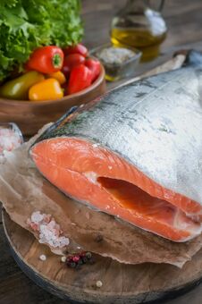 A Large Piece Of Salmon Lies On A Wooden Table For Cooking. Horizontal Frame. Royalty Free Stock Images