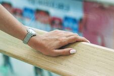A Beautiful Female Hand Holds Onto The Handrail In The Mall Stock Photo
