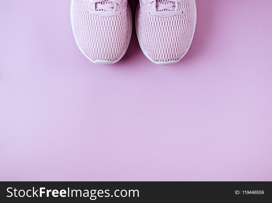 Violet sneakers pink background.