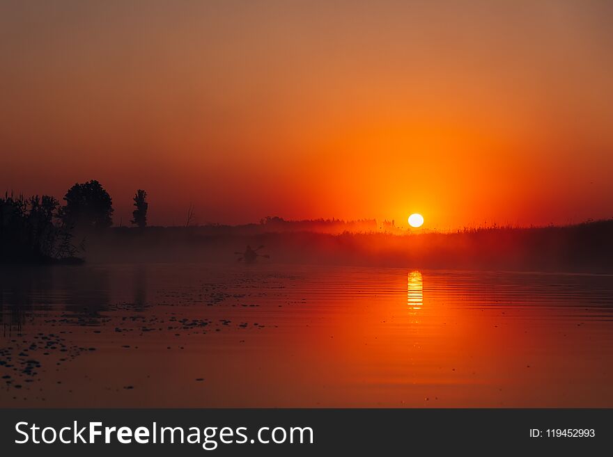 People kayaking down the river at sunrise