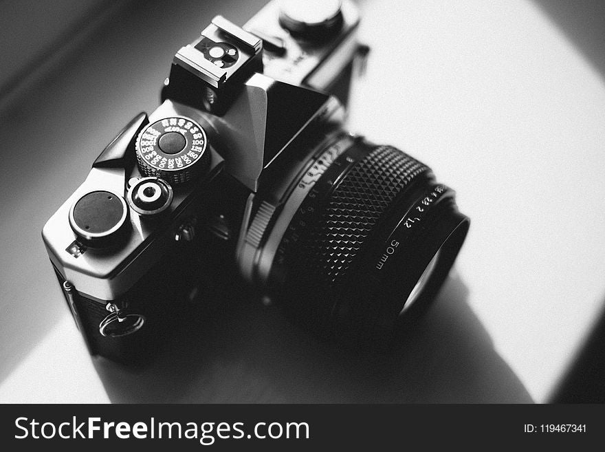 Black and Gray Dslr Camera on White Surface