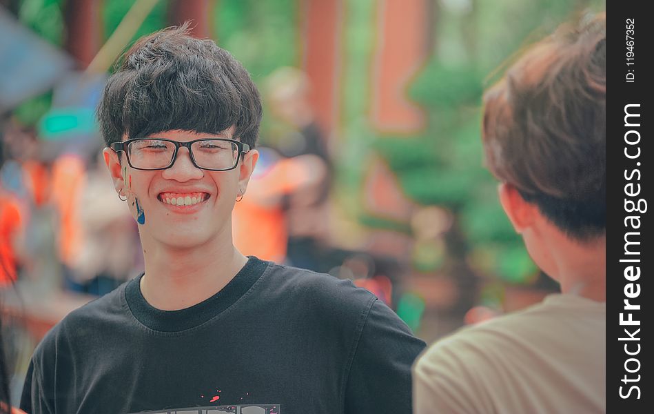 Smiling Man in Black Shirt Wearing Eyeglasses