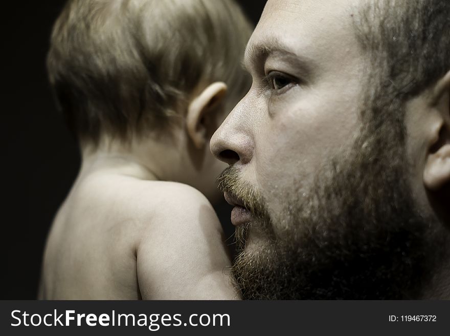 Photo of Man Carrying Baby