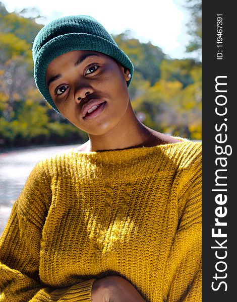 Woman Wearing Yellow Knit Sweater and Blue Knit Hat