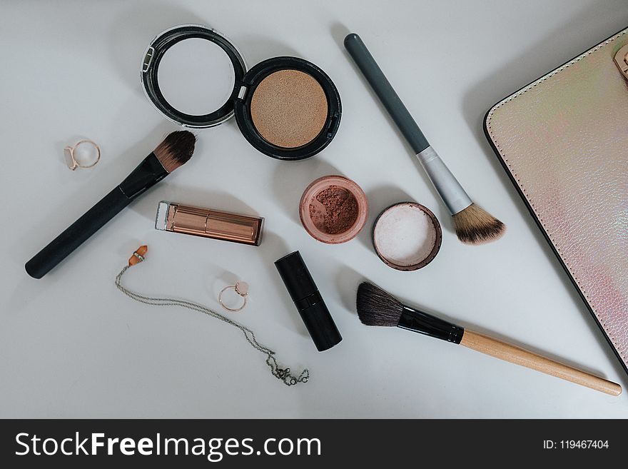 Flat Lay Photography of Makeup Brushes and Compacts