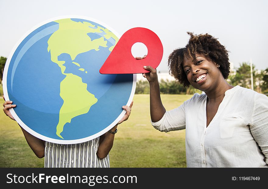 Woman Holding Plastic Arrow While Smiling