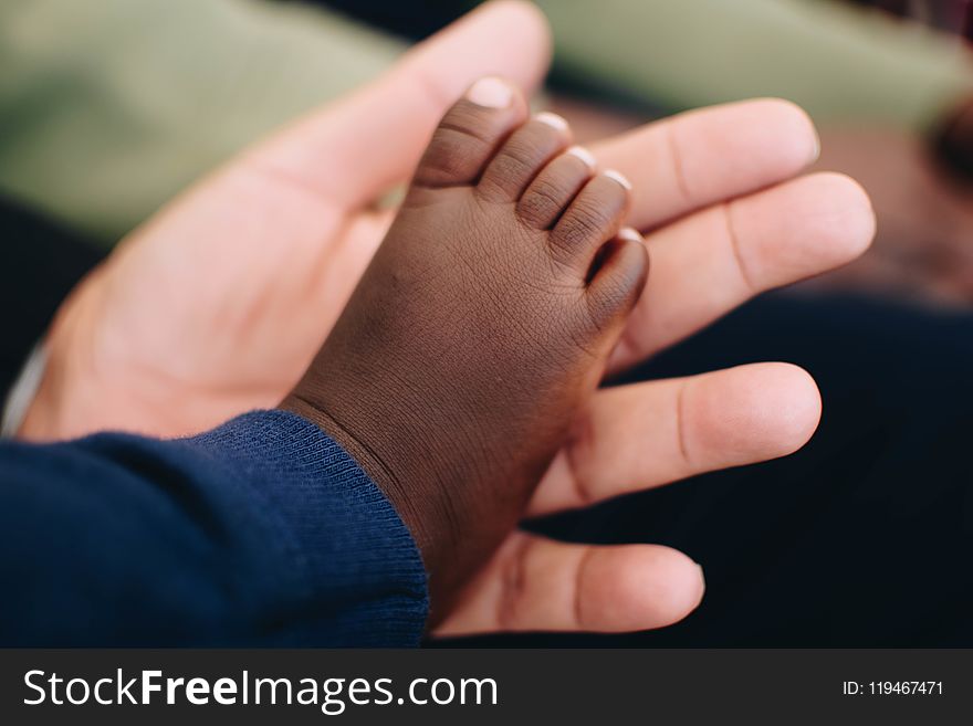 Baby&#x27;s Right Foot on Person&#x27; Left Palm
