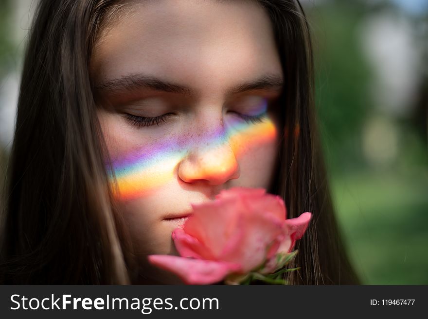 Close-up Photography Of Woman Smelling Pink Rose