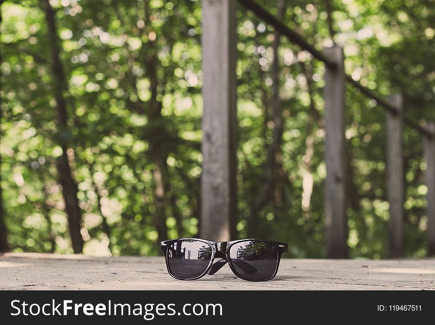 Black Framed Wayfarer-style Sunglasses On Floor