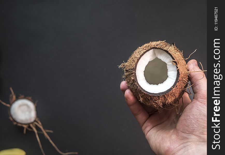 Person Holding Opened Coconut