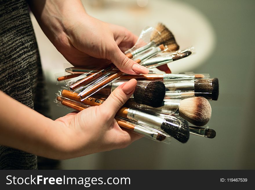 Person Holding Makeup Brushes