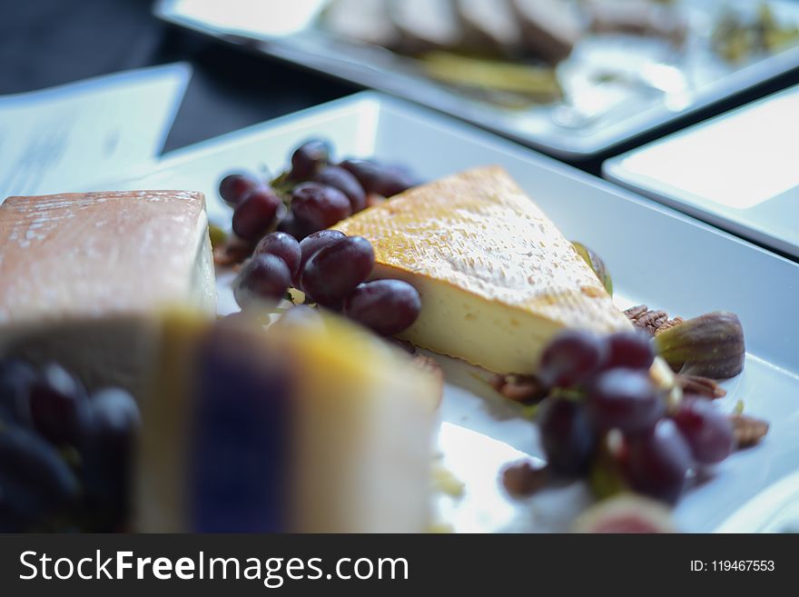 Shallow Focus Photography of Grapes and Sliced Cake