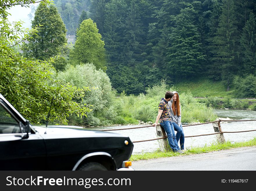 Man And Woman Sitting On Road Gutter