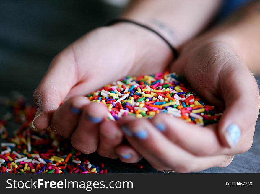 Person Holding Full of Sprinkles