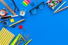 Education Concept. Stationery Frame With Glasses And Notebook On Blue Background Top View Copy Space Royalty Free Stock Photos