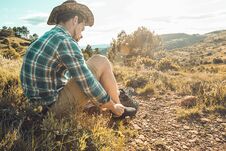 Man Tying His Boots On The Mountain Royalty Free Stock Photography