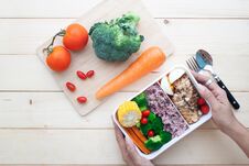 Top View Of Woman`s Hands Holding Healthy Lunch Box With Chicken Royalty Free Stock Photos