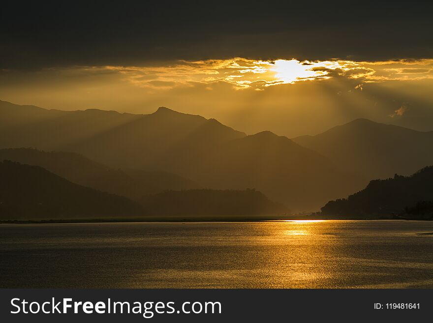 View on Fewa Lake and mountains during sunset in Pokhara, Nepal. View on Fewa Lake and mountains during sunset in Pokhara, Nepal