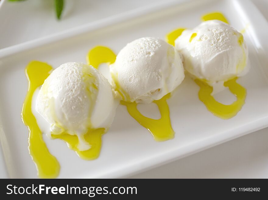 Bowl of Vanilla ice cream isolated on white background. Vanilla Ice Cream with Mint in bowl and Mangoes sauce