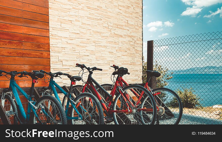 Eco-transport concept. Rental Bicycle bicycles for rent stand at row in the sea overview landscape. Eco-transport concept. Rental Bicycle bicycles for rent stand at row in the sea overview landscape