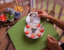 Fitness Woman Have A Breakfast. Healthy Homemade Oatmeal With Berries Royalty Free Stock Image